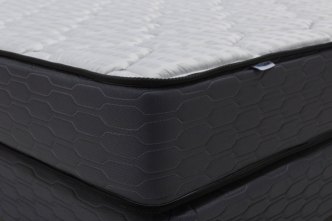Close-up of a modern mattress with a dark patterned base.