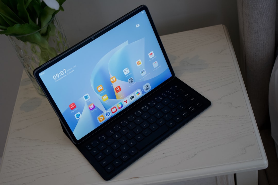 A tablet with a keyboard case on a table.