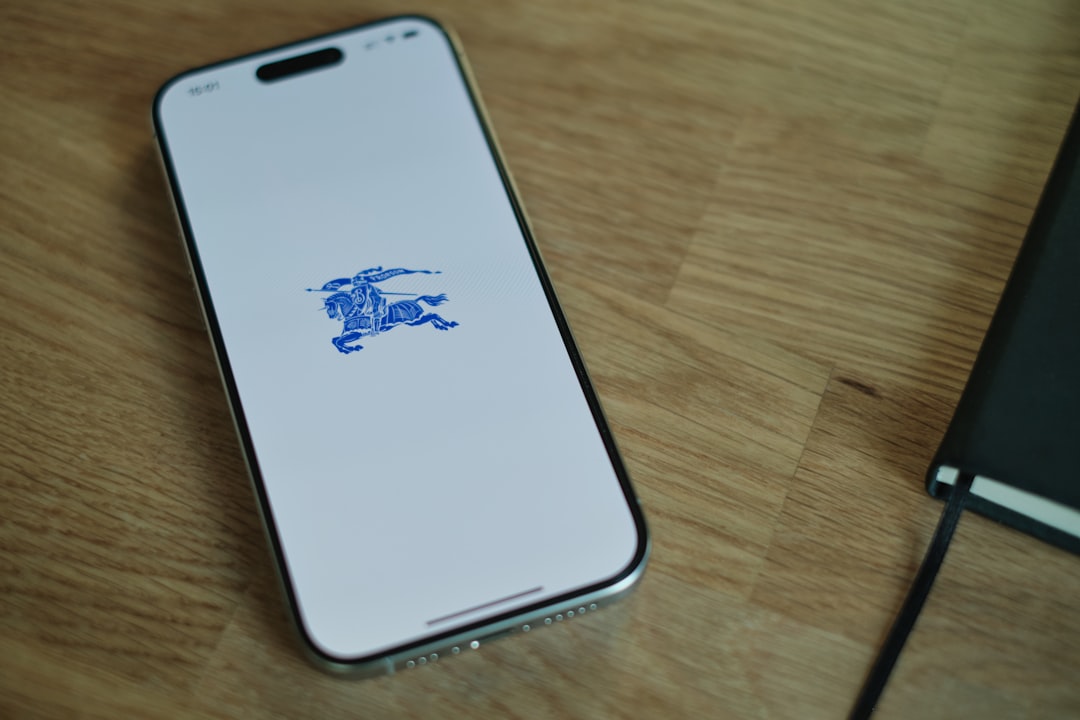 A cell phone sitting on top of a wooden table