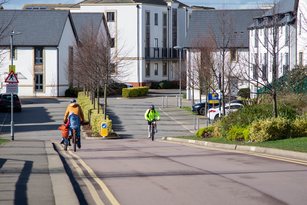 a couple of people riding bikes down a street