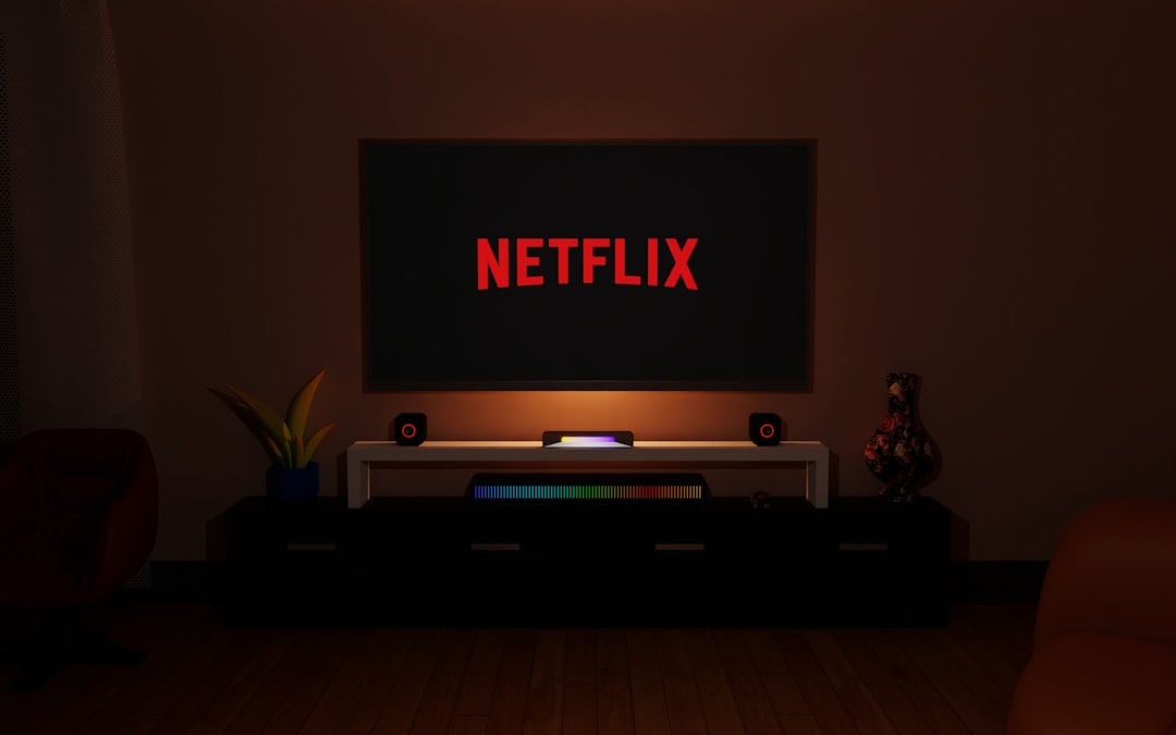 a dark room with a television and a neon netflix sign